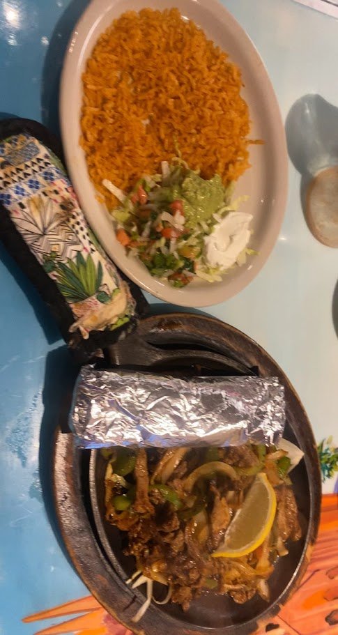Colorful plates served on a casual dining table.